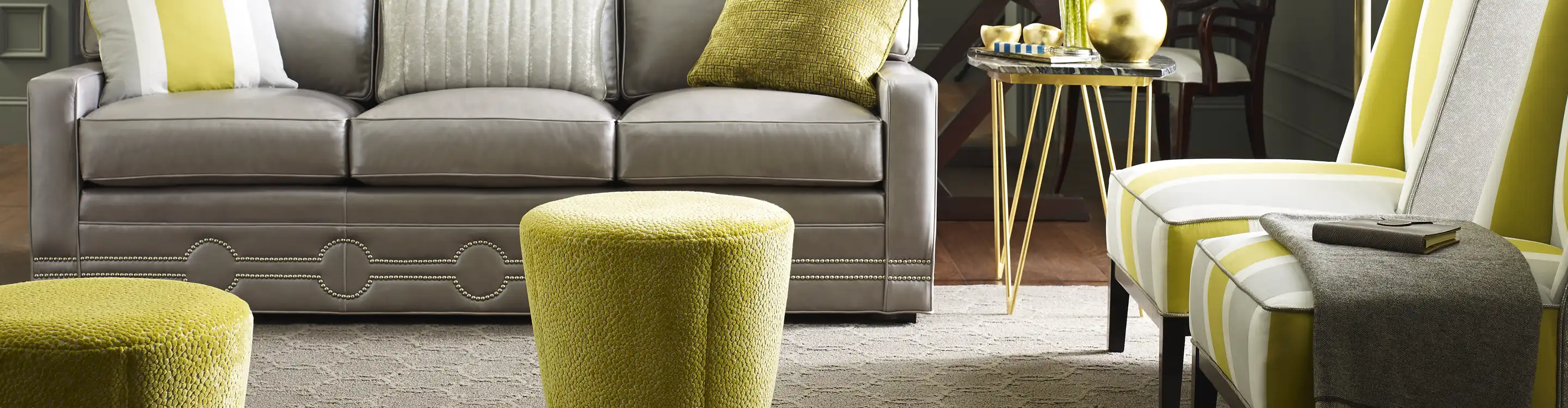 beige area rug in a living room with green accents